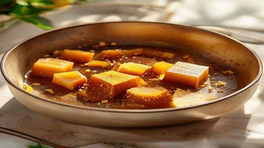 Amber brown butter with toasted flecks in a light pan
